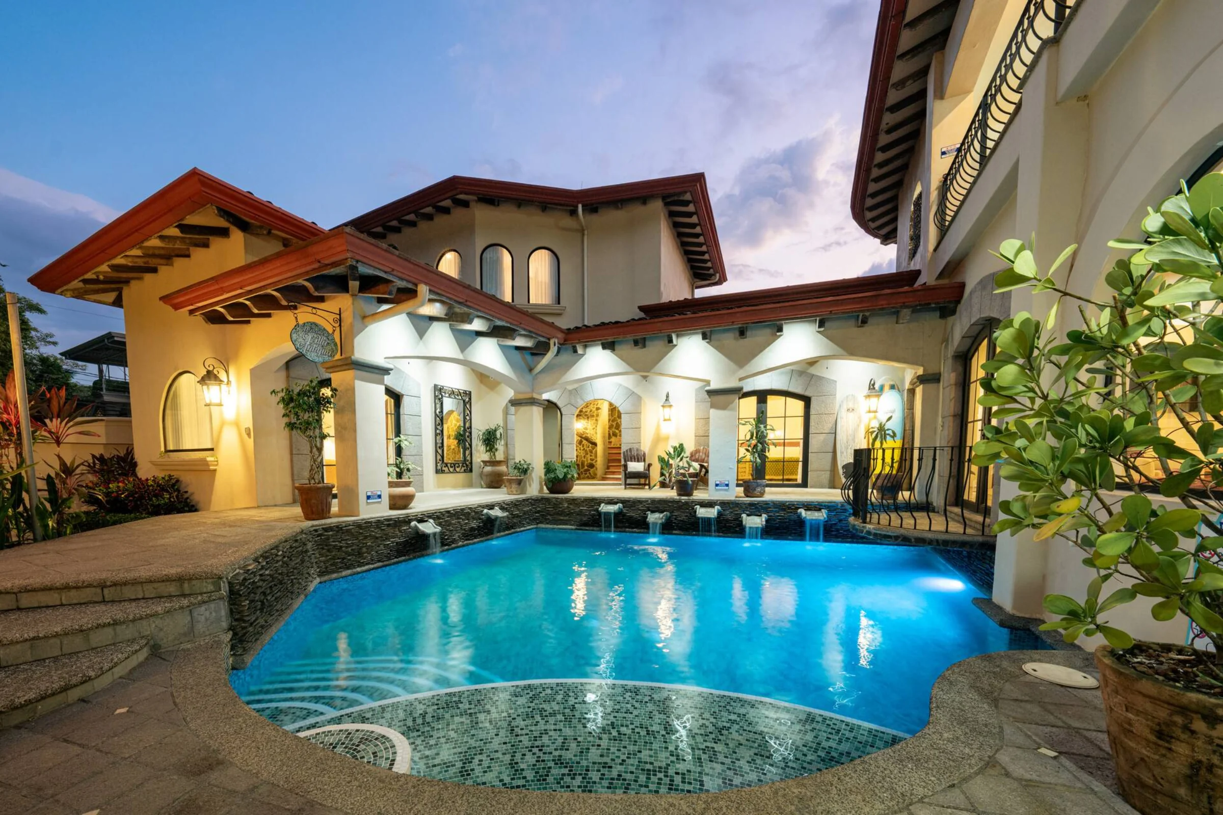 Pool and villa façade at twilight