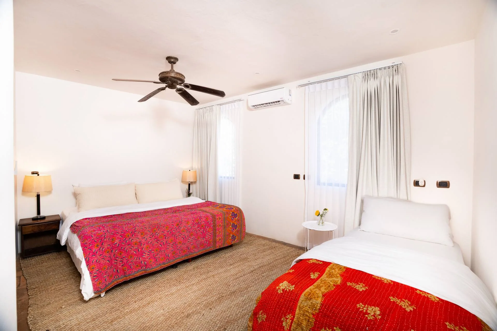 Bedroom with king bed and magenta bedspread